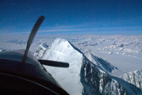 Paul Claus flies over the summit of Mt. St. Elias.