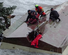 The Coast Guard assisted rescuing a fisherman from a capsized fishing vessel after it was washed ashore Saturday near Kodiak, Alaska.