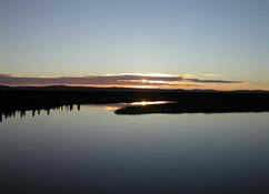 The sun sets on Alaska's summer, over the Fish River near White Mountain.